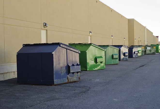 metallic dumpster units staged for construction garbage in Wellesley Hills